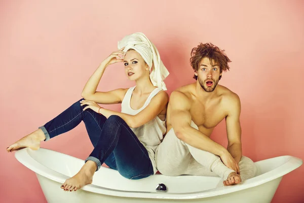 Женщина с полотенцем и удивленный мужчина на ванне — стоковое фото