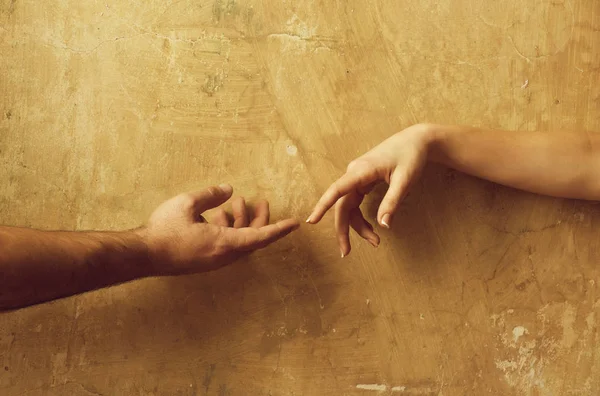 Male and female hands reaching to each other — Stock Photo, Image