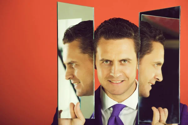 Man face with two sides reflecting in mirrors