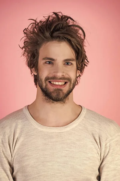 Sleepy man with beard on pink background