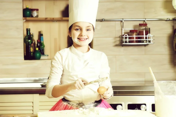 Menina engraçada fazendo massa — Fotografia de Stock