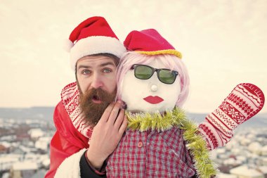 Sürpriz yüz adam Noel Baba. Hippi bulutlu gökyüzü üzerinde kırmızı xmas kılık. Kardan adam pembe peruk, eldiven ve gözlük. Noel ve yeni yıl kutlama. Kış tatil kavramı.