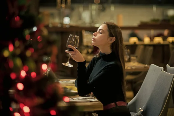 Perfect wine. bar customer sit in cafe drinking alcohol. girl with long hair drink red wine. Pretty woman rest in restaurant with wineglass. Date meeting of woman taster awaiting in pub.