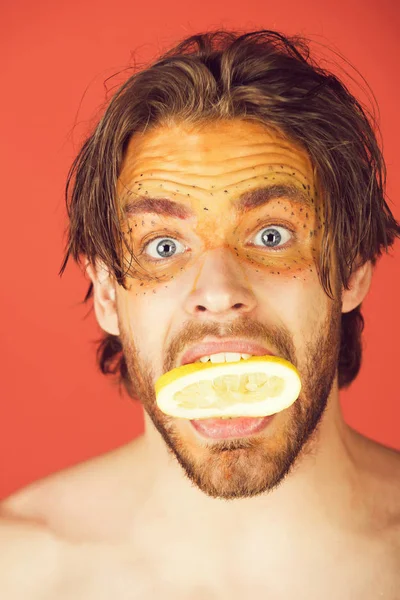 man with creative fashionable makeup hold lemon, vitamin