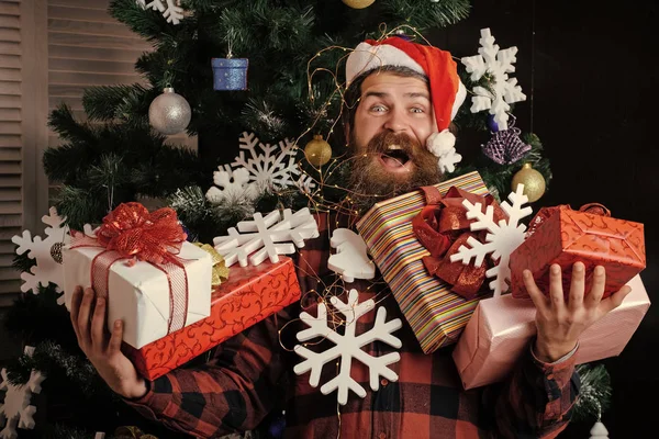Christmas man with beard on happy face hold gift.