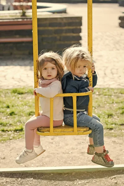 Bror och syster på swing solig dag — Stockfoto