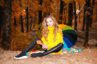 Doğa arka plan üzerine düşen yaprakları ile sonbahar kırmızı elbiseli güzel moda kadın. Trendy vintage kırmızı kazak veya kazak kaygısız genç kadın. Sonbahar sonbahar park kırmızı kazak ile kadında.