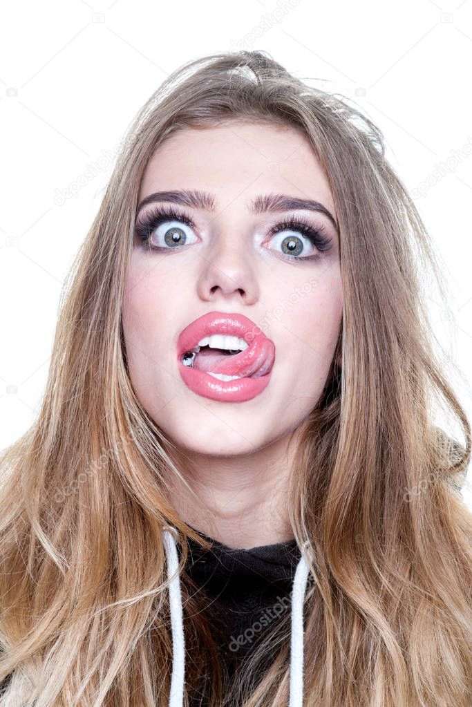 Portrait of a funny hipster girl looking at camera over white background. Comic woman. Close up portrait of surprised and funny woman.