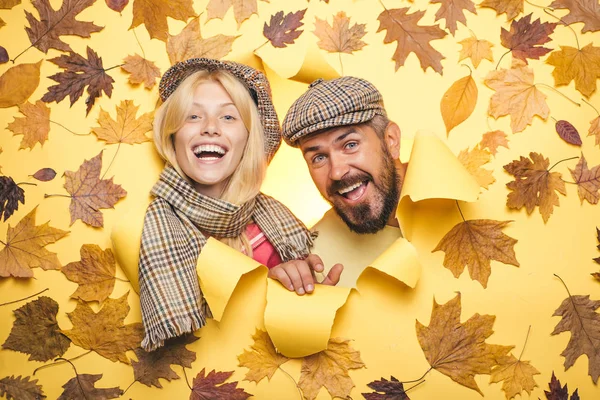 Autumn mood and the weather are warm and sunny and rain is possible. Romantic couple wearing pullover on autumn leaves background. Happy couple in love wearing in autumn clothes on autumn sunny day.