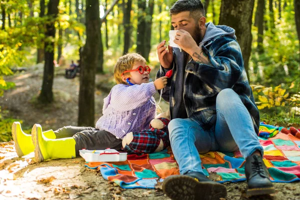 Baba ve oğul sonbahar ormanda oynuyor. Burun silecek Park sarı ağaçları arasında genç çocukla hapşırma. Baba ve çocuk evlat gülen ve having fun Sonbahar Park. — Stok fotoğraf