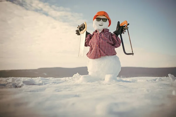 Snowman builder in winter in helmet.