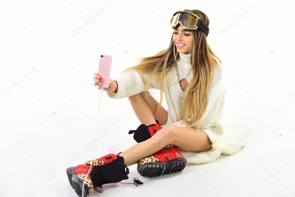 Winter holidays. Holyday atmosphere. Winter time fun. Ski resort and snowboarding. Winter sport and activity. Happy holidays. Girl in ski or snowboard wear. Sexy woman in winter clothes