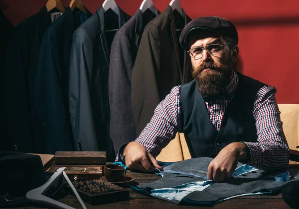 Is it good enough. Everything must be perfect. retro modern tailoring workshop. Bearded man tailor sewing jacket. sewing mechanization. suit store fashion showroom. business dress code. Handmade