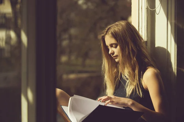 Linda chica leyendo libro en ventana abierta —  Fotos de Stock