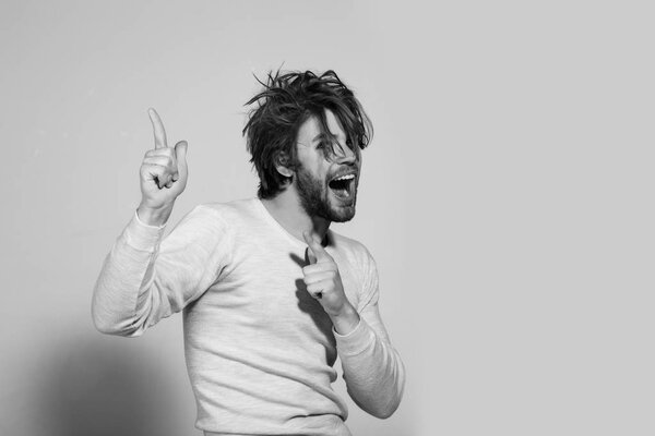 happy man with long uncombed hair wake up in morning