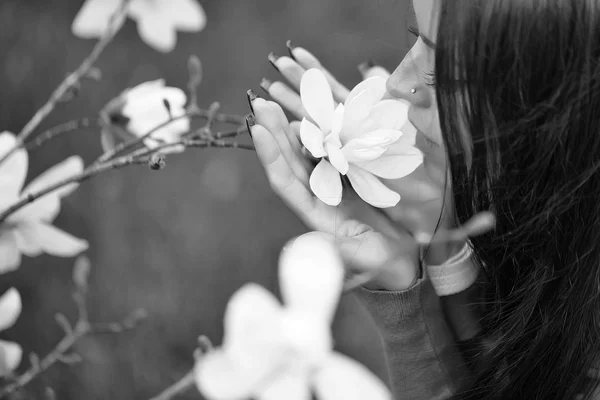 Pretty woman smells magnolia — Stock Photo, Image
