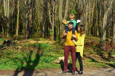 İnsanlar açık bahar Park'ta rahatlayın. Annem ve babam şirin küçük oğlu, insanlar kavramı piggybacking. Eğlenceli ve tüm gün oyun