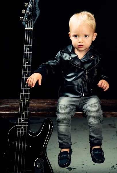 Make some noise. Little rock star. Child boy with guitar. Little guitarist in rocker jacket. Rock style child. Rock and roll music performer. Adorable small music fan. Small musician