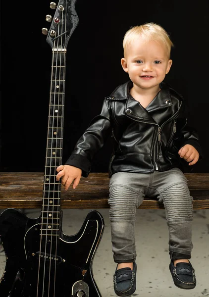 Im not prince Im rock and roll star. Child boy with guitar. Little guitarist in rocker jacket. Rock style child. Rock and roll music performer. Adorable music fan. Small musician. Little rock star
