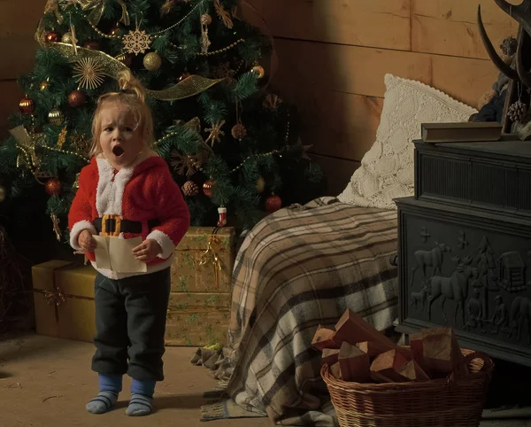 Christmas surprised child read wish letter.