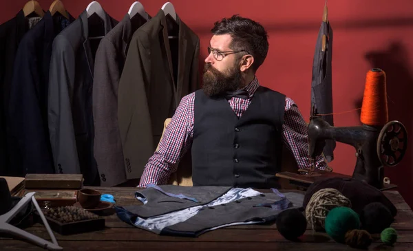 What design is better. business dress code. Handmade. retro and modern tailoring workshop. suit store and fashion showroom. sewing mechanization. Bearded man tailor sewing jacket. Perfect male