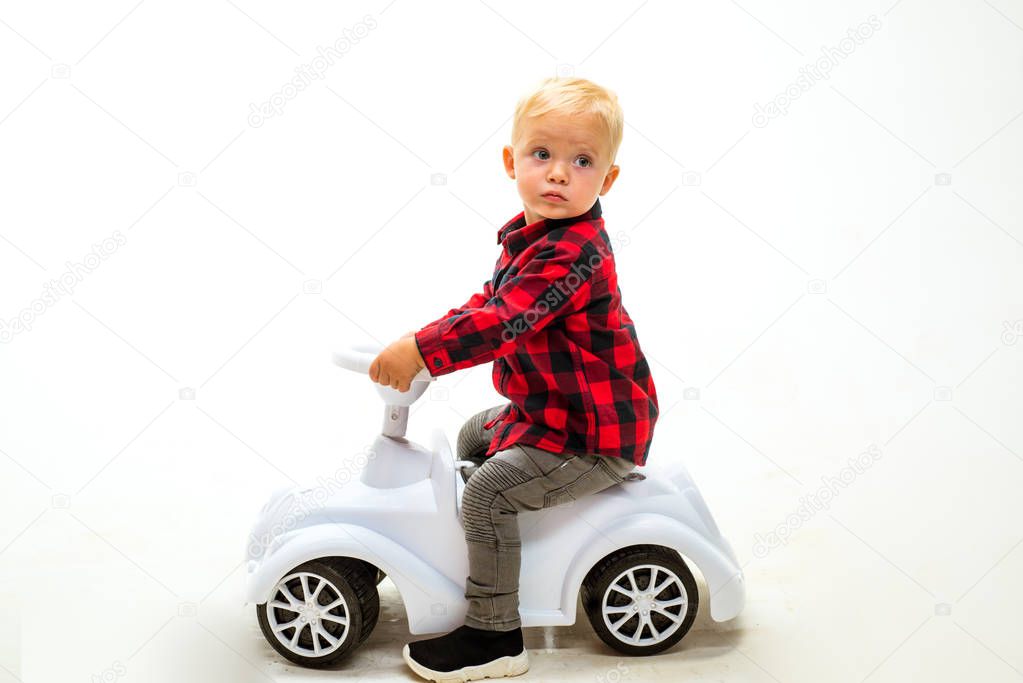 Simply just twist and go. Boy child on riding toy. Little child ride on toy car. Little baby enjoy playing in kindergarten. Small toddler builds balance and motor skills. Child day care or nursery