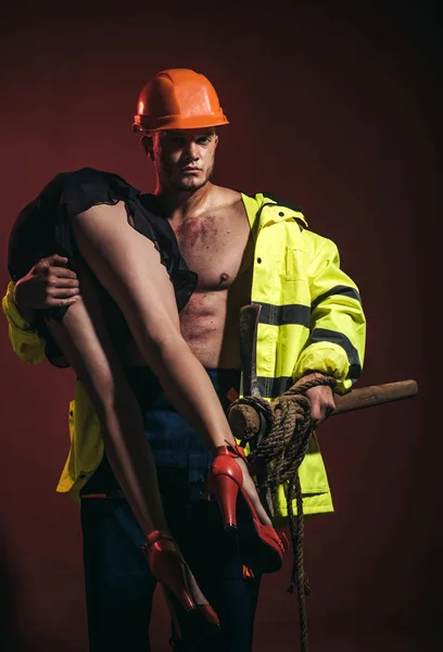 Passionate couple concept. Vibrant with passion. Sexual game is your passion. Firefighter sexy body muscle man holding saved girl. Hot and sexy.