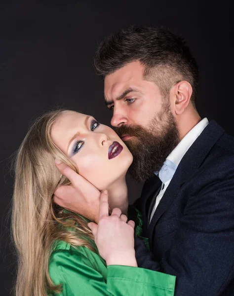 Making the relations exclusive. Bearded man hug woman with long hair. Couple in love. Style icons. Intimate couple in fashion clothing. Fashion style and hair care. They both love fashion — Stock Image Making the relations exclusive. Bearded man hug woman with long hair. Couple in love. Style icons. Intimate couple in fashion clothing. Fashion style and hair care. They both love fashion Royalty Free Stock Photos