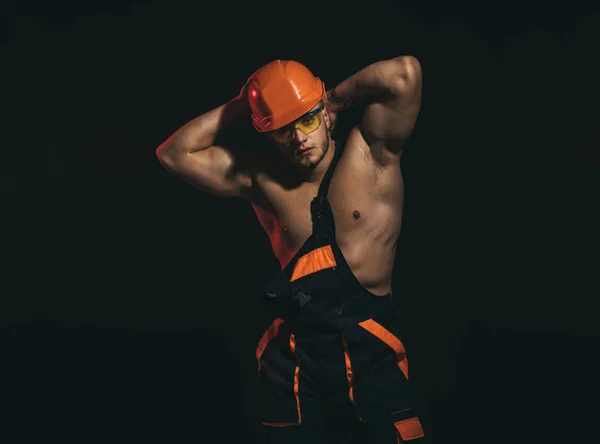 My work will be sure to impress. Construction worker or builder. Man worker with muscular sexy body. Handsome worker or workman. Muscular man wear hard hat and uniform. Confident and strong — Stock Photo, Image