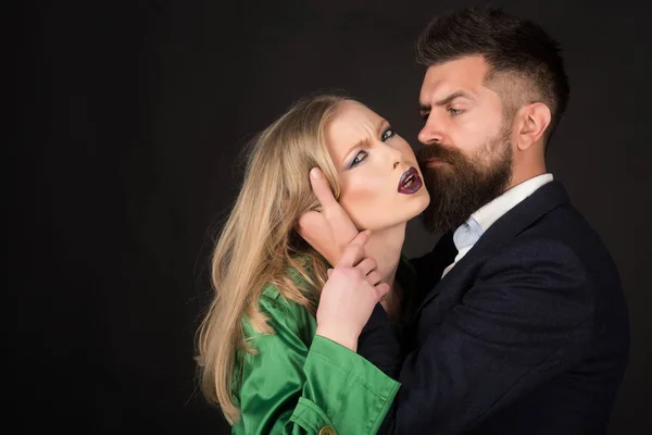 Love is on its way. Bearded man hug woman with long hair. They both love fashion. Couple in love. Intimate couple in fashion clothing. Fashion style and hair care. Style icons, copy space — Stock Image Love is on its way. Bearded man hug woman with long hair. They both love fashion. Couple in love. Intimate couple in fashion clothing. Fashion style and hair care. Style icons, copy space Stock Image