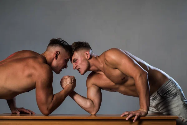 Energetic and full of strength. Twins men competing till victory. Revenge in sport. Twins competitors arm wrestling. Men competitors try to win victory or revenge. Strength skills — Stock Photo, Image