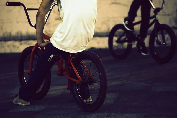 Twoo teenagers on bicycles