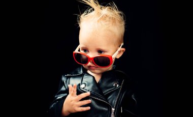 Music for children. Little child boy in rocker jacket and sunglasses. Little rock star. Rock style child. Rock and roll fashion trend. Adorable small music fan. Freedom to rock clipart