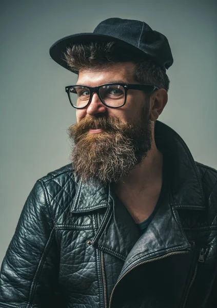 brutal caucasian hipster with moustache. Bearded man. Male barber care. Mature hipster with beard. hipster style. Man in biker leather jacket. happy man in glasses. Hair and beard care. happy.