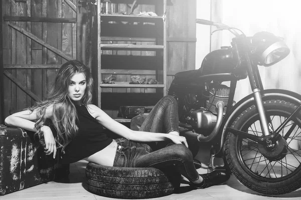 Girl lying in dirty rubber tire on floor — Stock Photo, Image