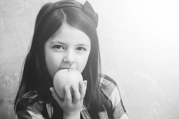 Pretty girl eating vitamin yellow apple Stock Picture