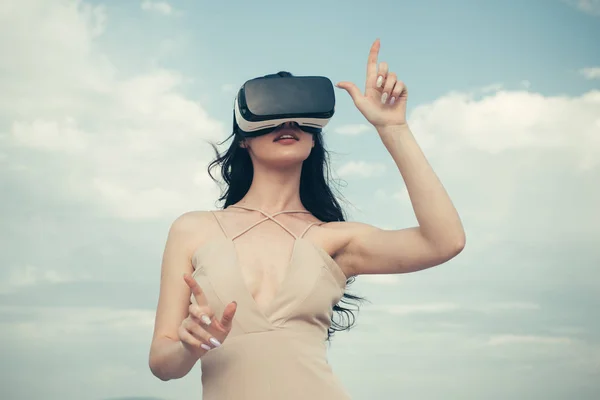 Visual reality concept. Digital future innovation. Woman with glasses of virtual reality. Girl using VR headset. Woman getting experience using VR-headset glasses. Fun with virtual reality headset