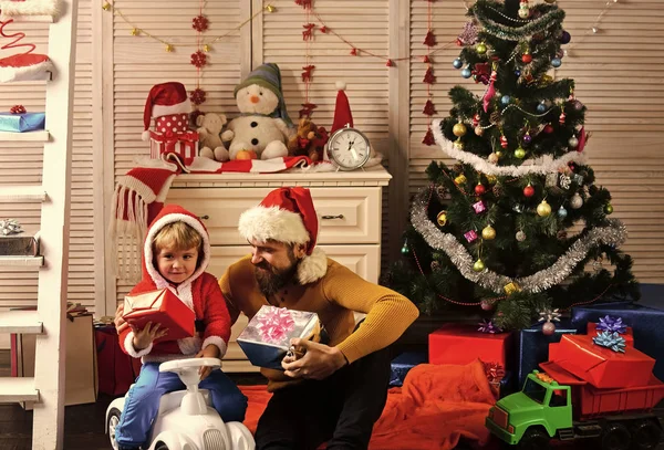 Christmas happy child and father with present box.