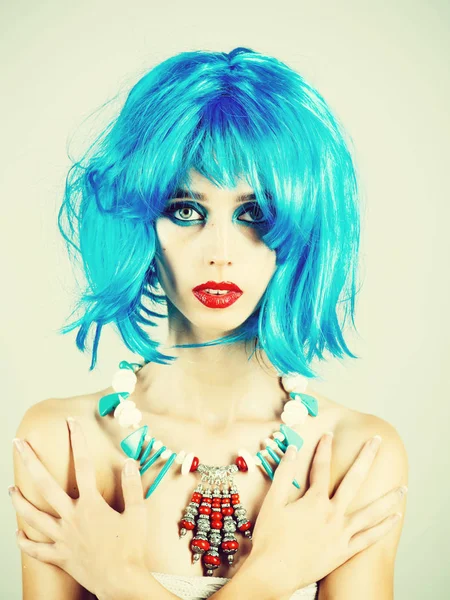 Woman in blue wig with fashionable makeup.