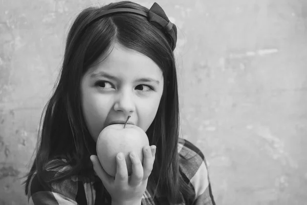 Adorable girl eating vitamin yellow apple — Stock Photo, Image