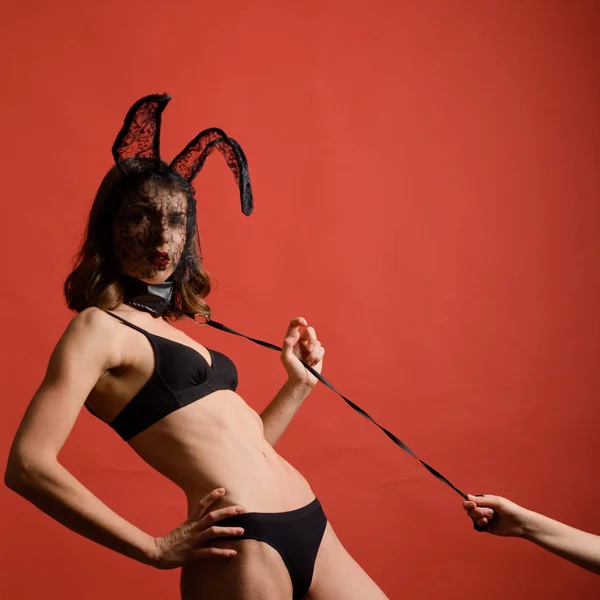 Female with sexy ass posing wearing bunny ears on Easter day. Rabbit easter. Beautiful sexy young woman wearing a black mask Easter bunny and looks very sensually. — Stock Photo, Image