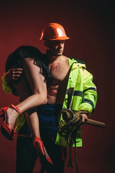 Hot sexy Firefighter. Muscle man holding sexy woman. Hot and sexy. Saved woman. Male leader. Superhero. Man power. Husband and wife concept.