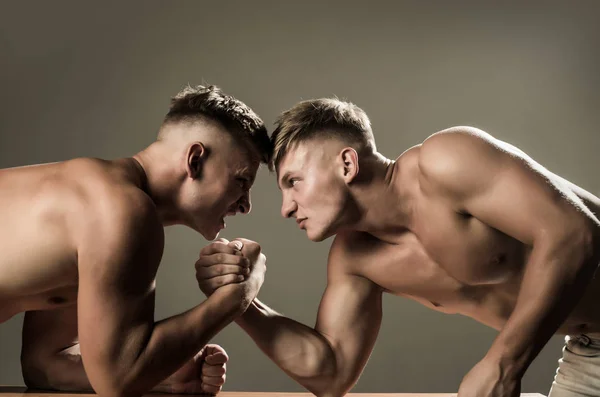 Tensão muscular e força. Gémeos a competir até à vitória. Habilidades de força. Competidores gêmeos braço de ferro. Homens competidores tentam ganhar vitória ou vingança. Vingança no esporte — Fotografia de Stock