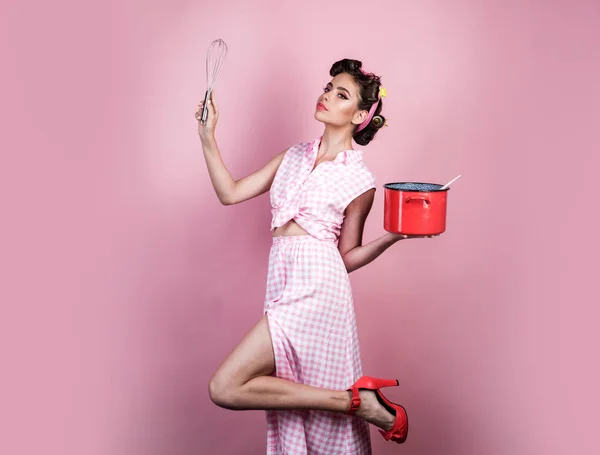 perfect housewife. pinup girl with fashion hair. retro woman cooking in kitchen. pin up woman with trendy makeup. pretty girl in vintage style. Enjoying new great day