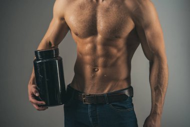 Anabolik steroidler ile kas büyüme uyarıcı. Anabolik hormon kas gücü artar. Vitamini besin. Sağlıklı beslenme. Güçlü adam vitamin şişeleri tutun. Adam altı bohça abs. bir diyet tutulması ile