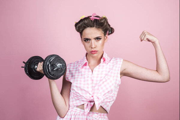 pin up woman with trendy makeup. retro woman with dumbbell. Sport. pinup girl with fashion hair. pretty girl in vintage style. powerful housewife. Exercising with dumbbells