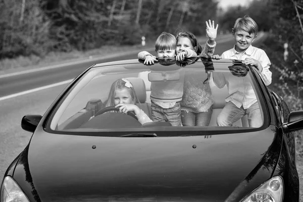 Happy children friends in car — Stock Photo, Image