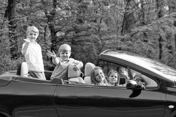 Happy children friends in car — Stock Photo, Image