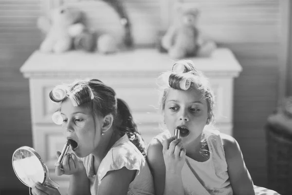 Little girls do makeup sitting in room with toys — Stock Photo, Image