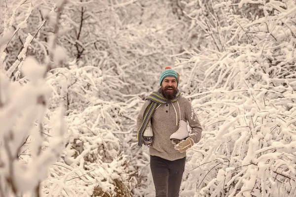 Homem barbudo com patins na floresta nevada . — Fotografia de Stock